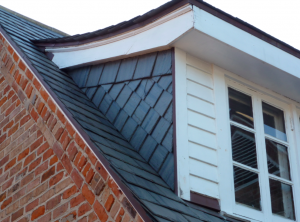 This dormer features Vermont Black installed in a German style.