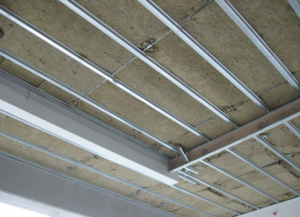 Drywall ceilings hung on resilient hangers in conjunction with a lightweight roofing system provide even greater sound isolation by virtue of the resilient connection or “decoupling” of the drywall layer from the rest of the building structure.