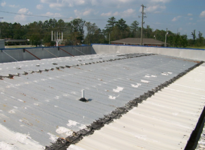 Caulk, roof coating and tar patches were used to cover leaking fasteners and panel end laps.