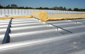 This new standing-seam roof is being installed with 4 inches of additional insulation.