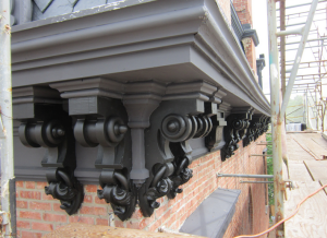 The cornice ornamentation and decoration beneath the built-in gutters is no small feat to replicate.  