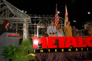 At the 2006 METALCON, Show Director Claire Kilcoyne presented a new steel-framed ADA-compliant home to U.S. Army Staff Sgt. Paul Russell Marek of Satellite Beach, Fla. Marek’s parents, Paul and Rose Marek, were there to help him accept the home.