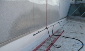 The team first sprayed the exposed base flashings with water, then rose up to the counterflashing, then further up the wall, then to the sill of the windows above, etc. Testing moved laterally to a new position before starting again.
