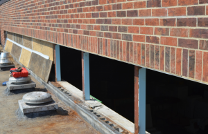 PHOTO 4: The clerestory windows at SD 73 Elementary North were removed and revealed concrete masonry units with open cores, which were grouted solid prior to raising the sill.