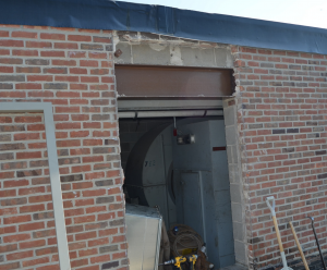 PHOTO 7: A low roof structural beam at the head of the door was prepped, primed and painted at SD 113 Deerfield High School.