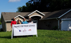 From left to right: Bobby Shifteh, Jasper Contractors’ business development manager, and Arielle Dysart, chief operating officer, pose with Paul and Colette Singrossi in front of their newly reroofed home in Winter Springs, Fla.