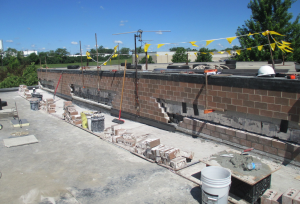 PHOTO 8: The masonry contractor segmented the demolition so the brick above could be supported.