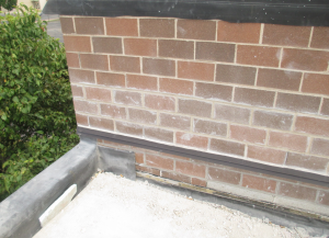 PHOTO 9: The through-wall flashing has been raised to a new height to accommodate the additional insulation.