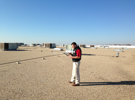 A technician from Sheridan, Ark.-based RoofConnect walks a roof and documents it as part of an annual maintenance survey. RoofConnect, which has locations around the country, including Monroe, N.C., has made maintenance contracts a major part of its business.