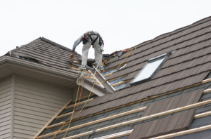 An installation team from Metal Roof Outlet, Courtland, Ontario, Canada, installs an Allmet stone-coated metal roof on a suburban Toronto home.