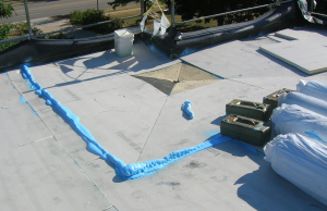 PHOTO 8: The roof drains were extended with the new reversible collar pinning the existing EPDM to maintain the integrity as a vapor retarder. A 1/2-inch-per-foot tapered insulation sump is being installed, tapering the top layer of insulation to the new roof-drain extension.