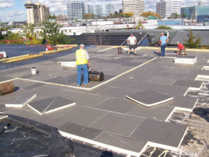 The roof insulation panels were “walked-in” immediately following placement and periodically “rolled” with a counterweight to ensure a satisfactory bond to the deck.