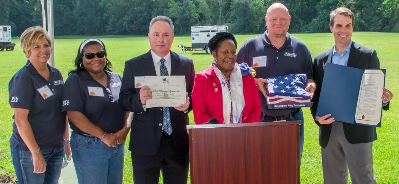 Congresswoman Sheila Jackson presents NCI a flag that was flown over the U.S. Capital building and a Certificate of Congressional recognition during National Manufacturing Day.