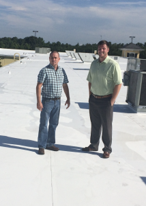 Anthony Wilkerson (left) and Blake Wideman of Peach State Roofing’s Charlotte branch inspect the completed project at Premium Outlets in Gaffney, S.C. 